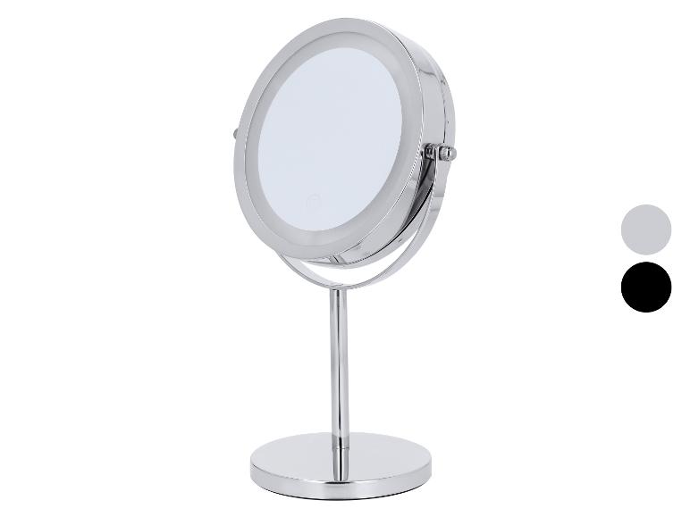 Miroir de maquillage rond chromé avec éclairage LED et base stable.