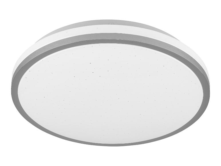 Un plafonnier rond et blanc avec une bordure argentée.