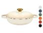 Cocotte en fonte couleur crème avec un bouton doré et des échantillons de couleurs