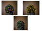 Trois guirlandes lumineuses LED solaires de différentes couleurs sur une plante en pot.