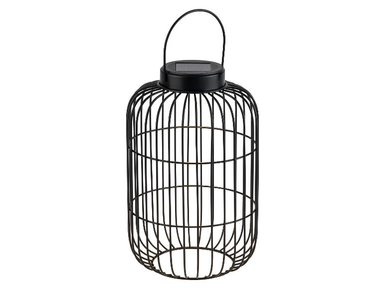 Lanterne solaire décorative noire en métal avec un design en cage.