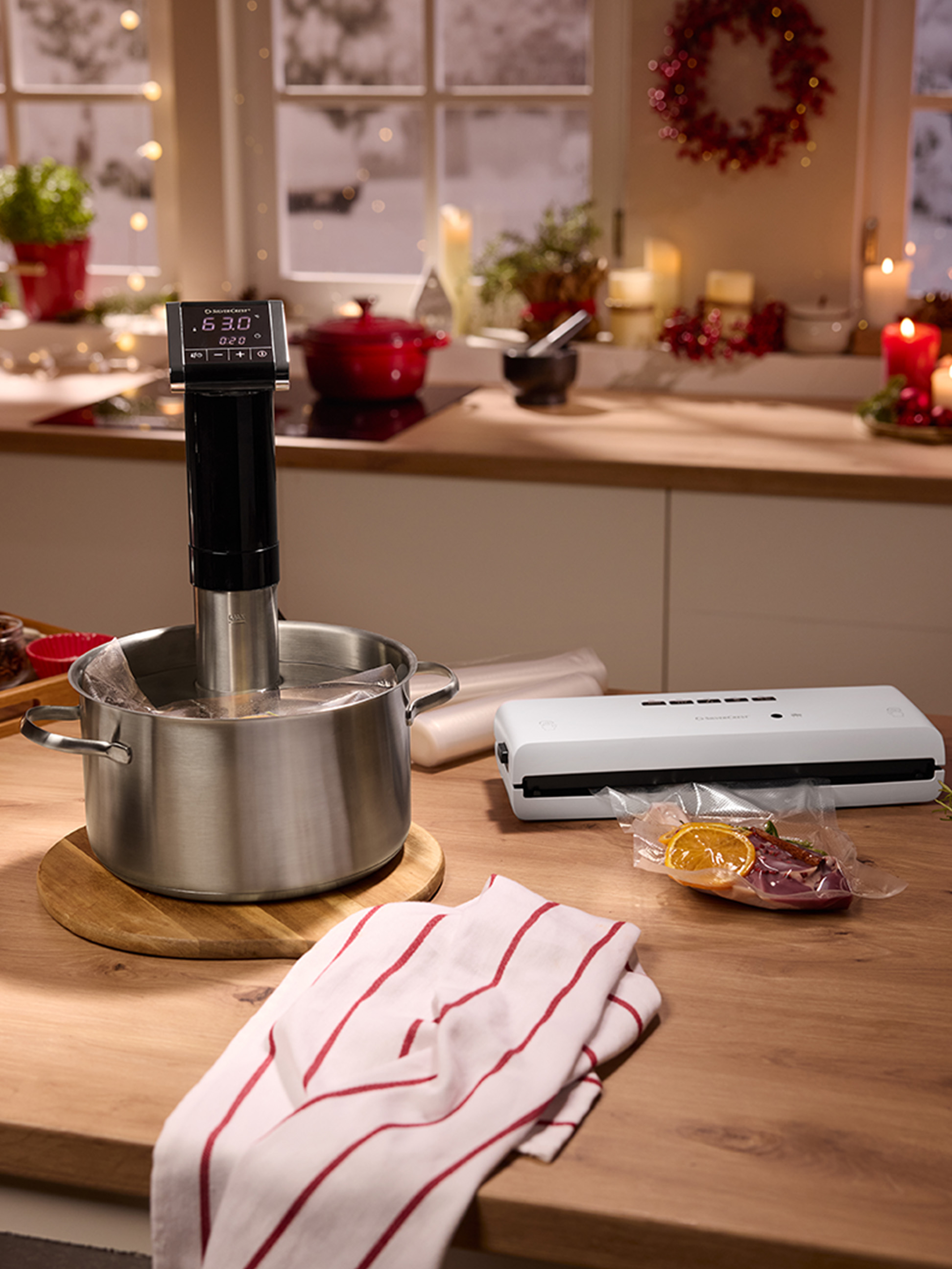Appareil sous vide et machine sous vide sur un comptoir de cuisine décoré pour les fêtes.