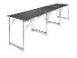 Longue table de camping pliable avec plateau noir et pieds en aluminium.
