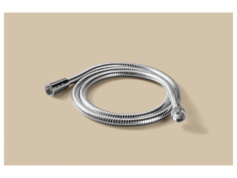 Flexible de douche métallique argenté enroulé sur un fond beige.
