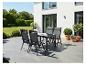 Ensemble de table de jardin avec quatre chaises sur une terrasse moderne.