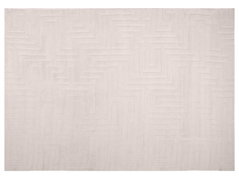 Tapis beige clair avec un motif géométrique de labyrinthe