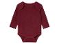 Un body bébé à manches longues de couleur bordeaux.