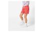 Une fille portant un short rose et des baskets blanches