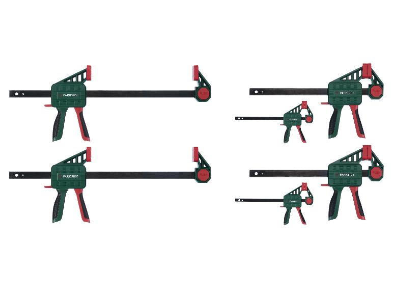 Quatre serre-joints, deux grands et deux petits, sur fond blanc