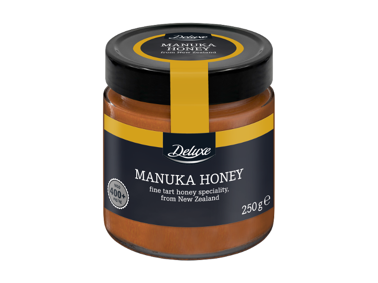Miel DELUXE Manuka, pot de 250g avec étiquette noire et détails jaunes, indiquant 400+ MGO.