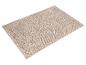 Tapis de bain rectangulaire beige avec surface texturée à picots