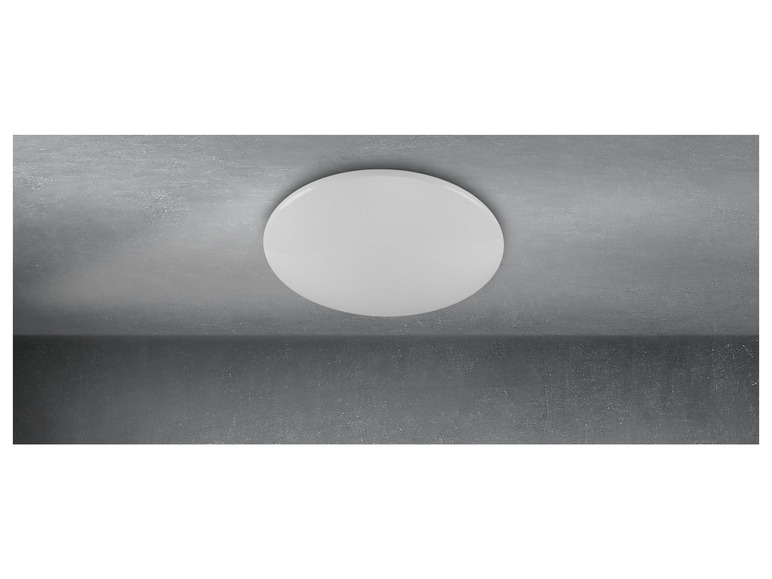 Un plafonnier rond blanc sur un fond gris.