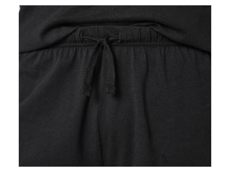 Détail de la taille élastique avec cordon de serrage d'un pantalon de survêtement noir.