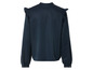 Une blouse bleu marine à manches longues avec des volants sur les épaules.
