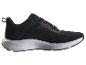 Chaussures de sport noires avec détails orange et semelle blanche