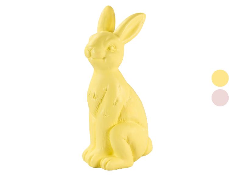 Figurine de lapin de Pâques jaune avec deux échantillons de couleur à droite.