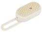 Brosse de massage du cuir chevelu blanche avec picots et boucle de suspension.