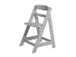 Une chaise haute Tripp Trapp grise.