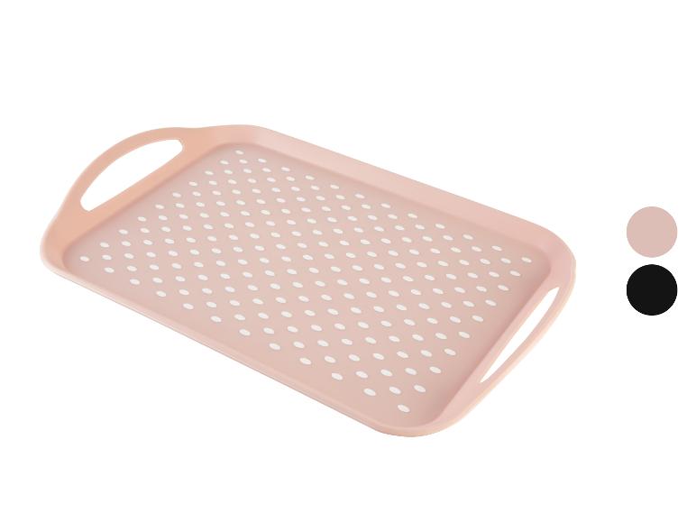 Plateau rose à pois blancs avec poignées.