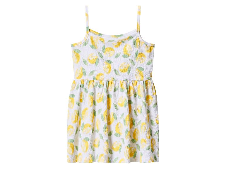 Robe blanche à fines bretelles pour enfant avec motif citrons et feuilles.