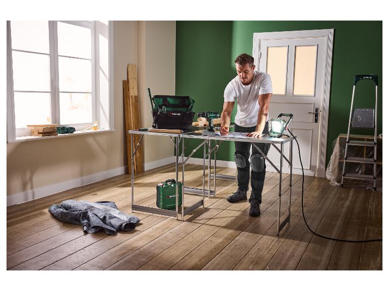 Homme avec outils Parkside et établi, préparant des travaux de rénovation.