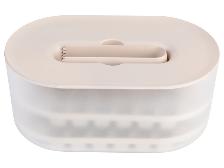 Une boîte en plastique beige avec une pince pour servir des glaces.