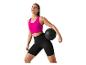 Femme en vêtements de sport tenant un ballon de médecine.