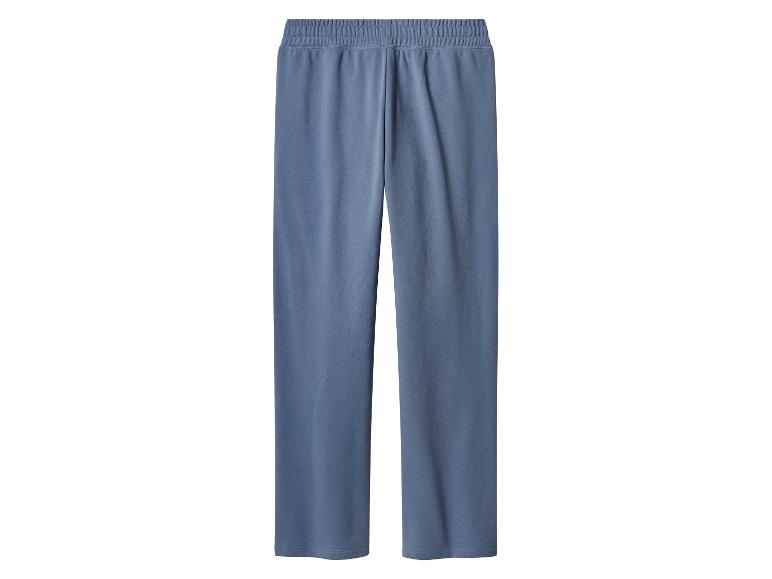 Pantalon de survêtement bleu, ample, avec taille élastique.