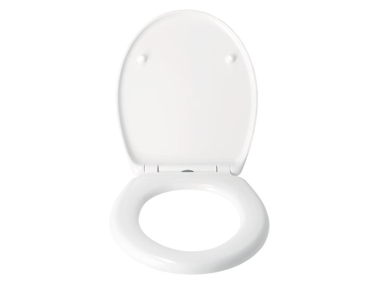 Un abattant de toilettes blanc, ouvert.