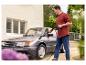 Homme lavant une voiture avec un nettoyeur haute pression.
