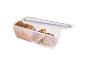 Boîte alimentaire transparente avec du pain complet et des petits pains aux graines.