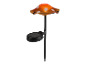 Lampe solaire en forme de champignon orange à pois blancs.