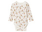 Un body blanc pour bébé à manches longues avec un motif floral.