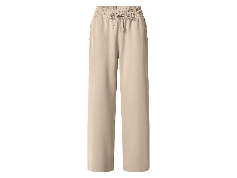 Pantalon de jogging large beige avec cordon de serrage à la taille.