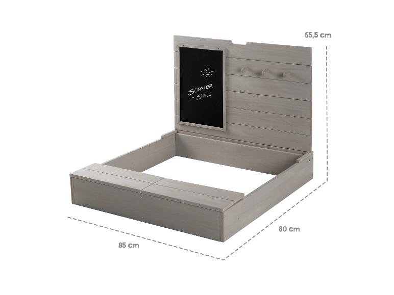Bac à sable en bois avec tableau noir et bancs.