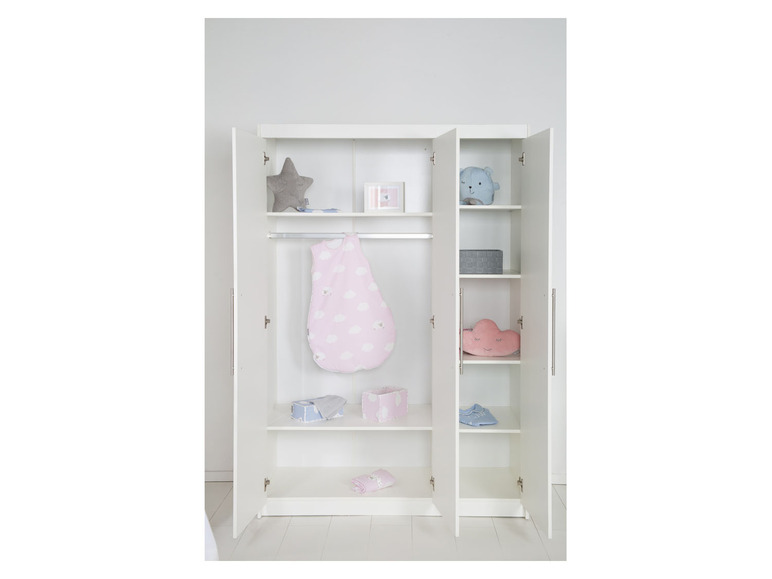 Une armoire blanche avec des portes ouvertes, remplie de vêtements et d'accessoires pour bébé.