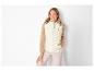 Une femme porte une veste matelassée blanche de la marque Camel Active.