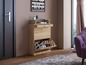 Une armoire à chaussures en bois avec un tiroir et une étagère ouverte pour les chaussures.