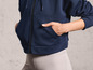 Un sweat-shirt bleu marine zippé avec un legging gris.