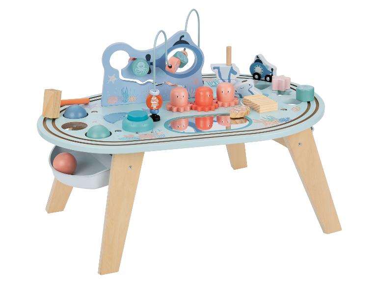 Table d'activités en bois pour enfants sur le thème marin avec divers jeux.