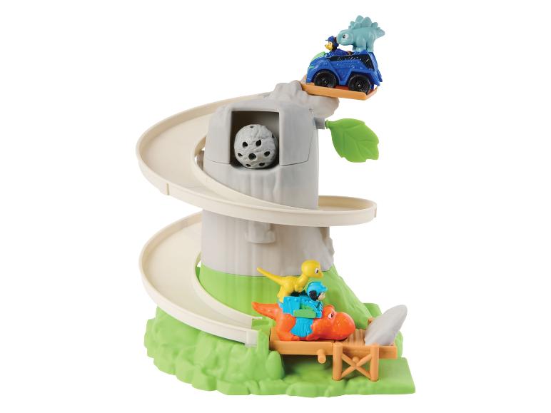Circuit de jeu en forme d'arbre avec des dinosaures et une voiture bleue.