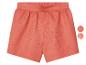 Shorts en lin, couleur corail, avec options de motifs.