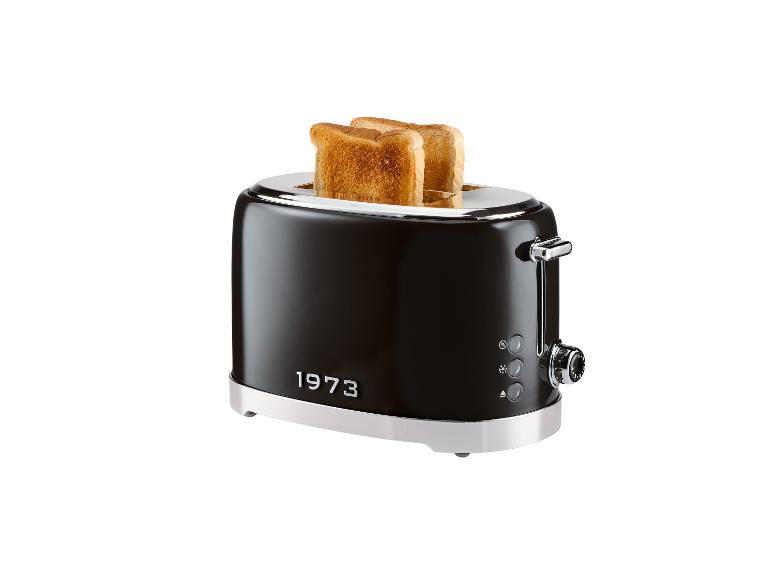Un grille-pain rétro brun foncé 1973 avec du pain grillé.