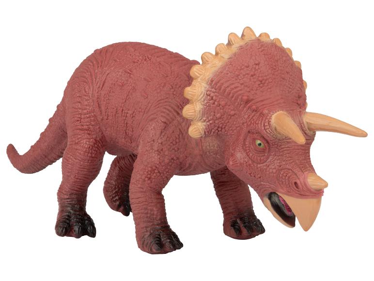 Un jouet de dinosaure en plastique rouge, un Triceratops.
