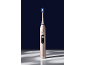 Brosse à dents électrique dorée à poils bleus, affichant 'Clean' et une icône de dent.
