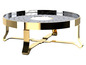Un plateau doré avec une grille ronde et quatre pieds.