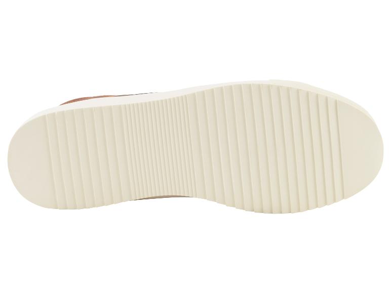 La semelle blanche d'une basket marron.