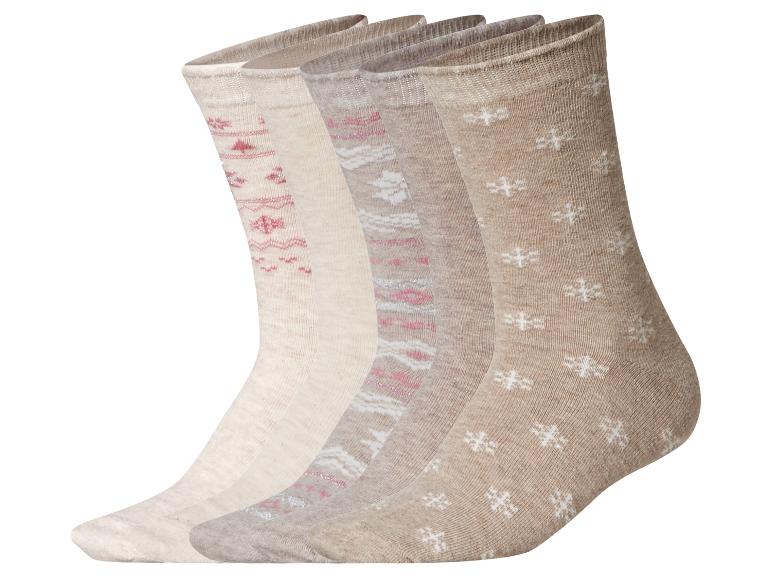 Ensemble de cinq paires de chaussettes beiges avec divers motifs, y compris des flocons de neige roses et blancs.