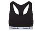 Un soutien-gorge de sport noir avec une bande Reebok blanche.
