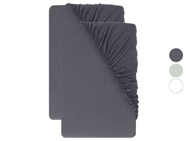 Deux draps-housses gris foncé avec coins élastiqués, avec des échantillons de couleurs à droite.